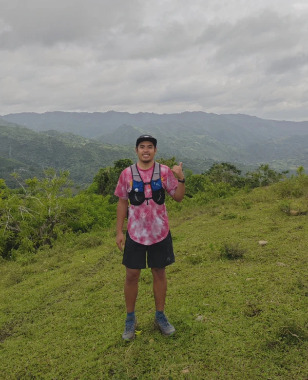 A man standing on top of wearing pink shirt